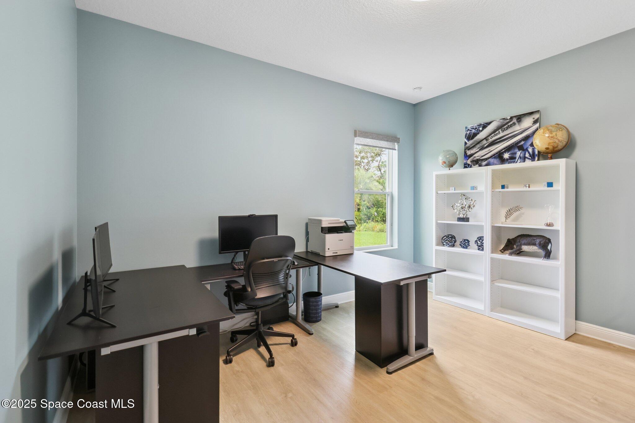4437 Preservation Circle Melbourne, FL 32934 - Photo 14 of 40 a view of a workspace with furniture and a window
