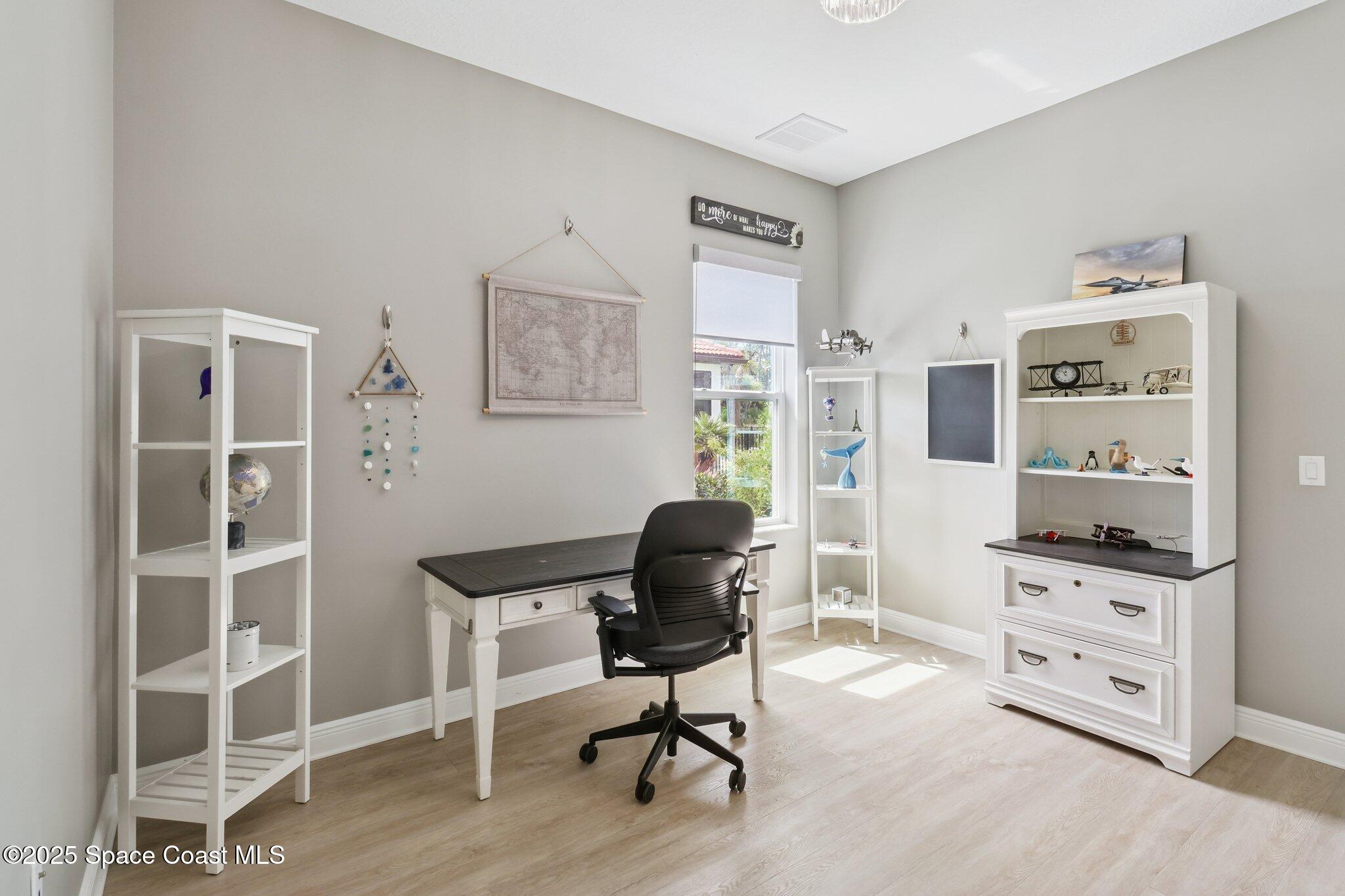 4437 Preservation Circle Melbourne, FL 32934 - Photo 16 of 40 a view of a workspace with furniture and a window