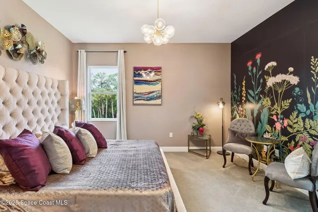 a bedroom with a bed and a chandelier