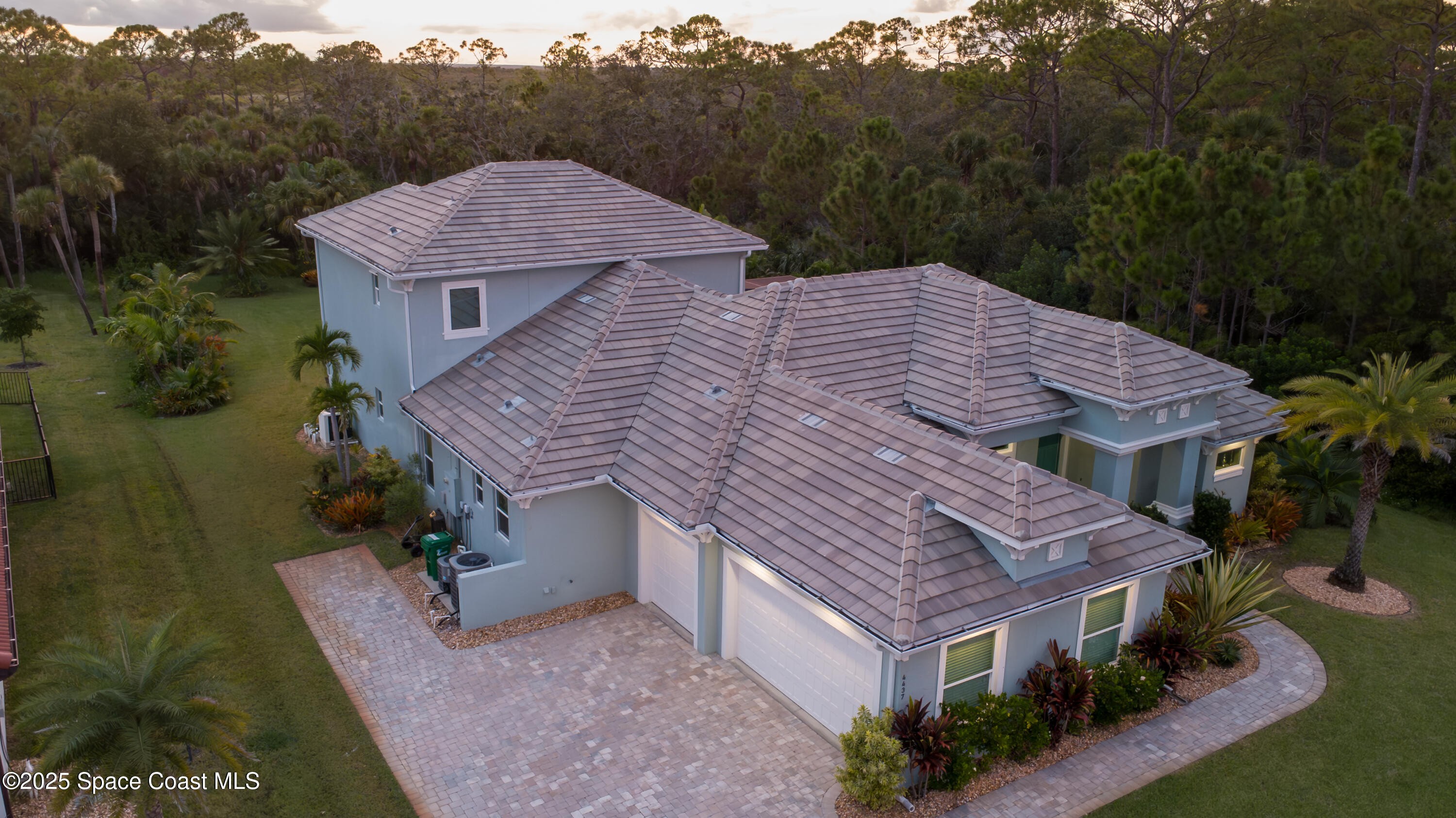 4437 Preservation Circle Melbourne, FL 32934 - Photo 31 of 40 a aerial view of a house with a yard and a large tree
