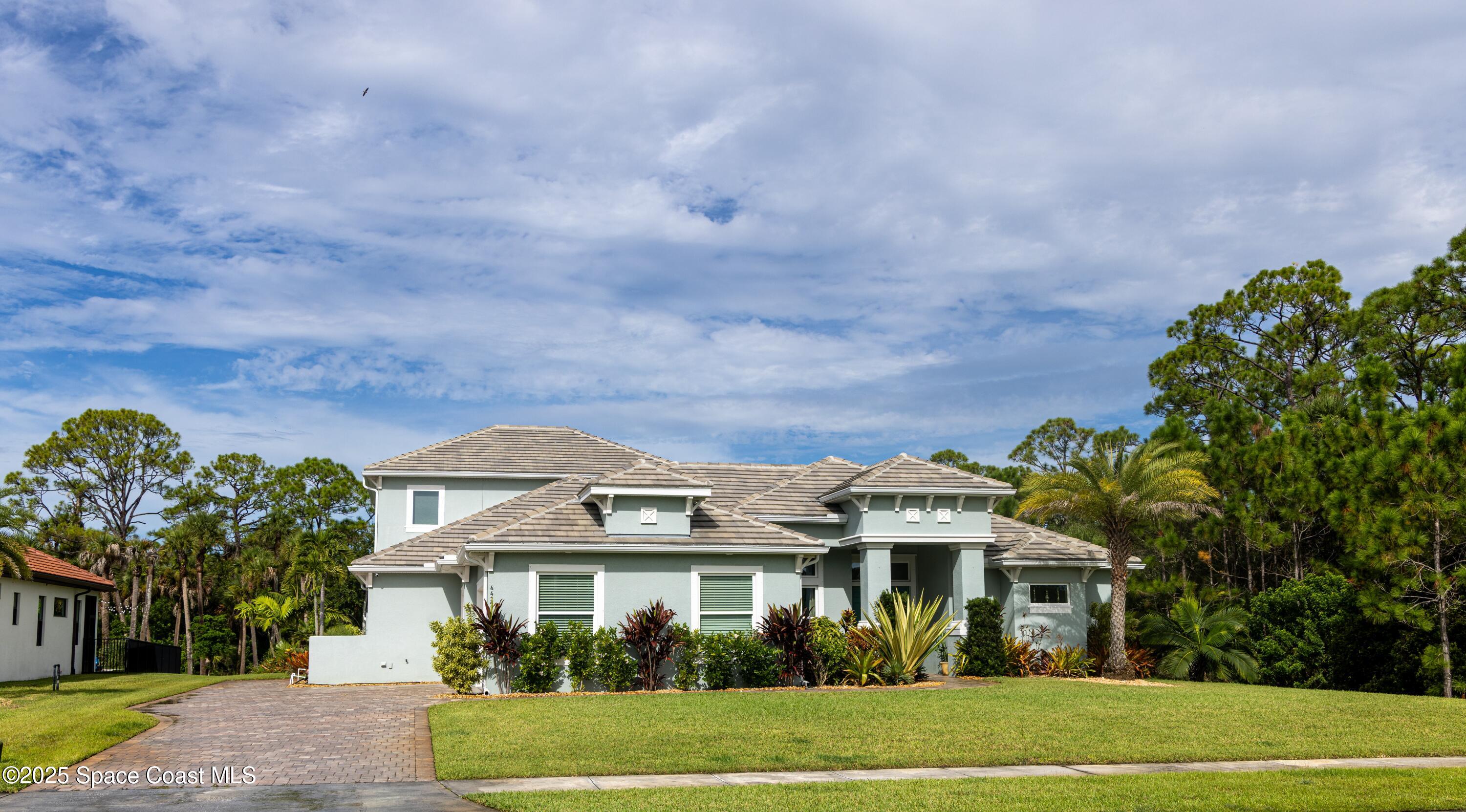 4437 Preservation Circle Melbourne, FL 32934 - Photo 32 of 40 a front view of a house with a garden