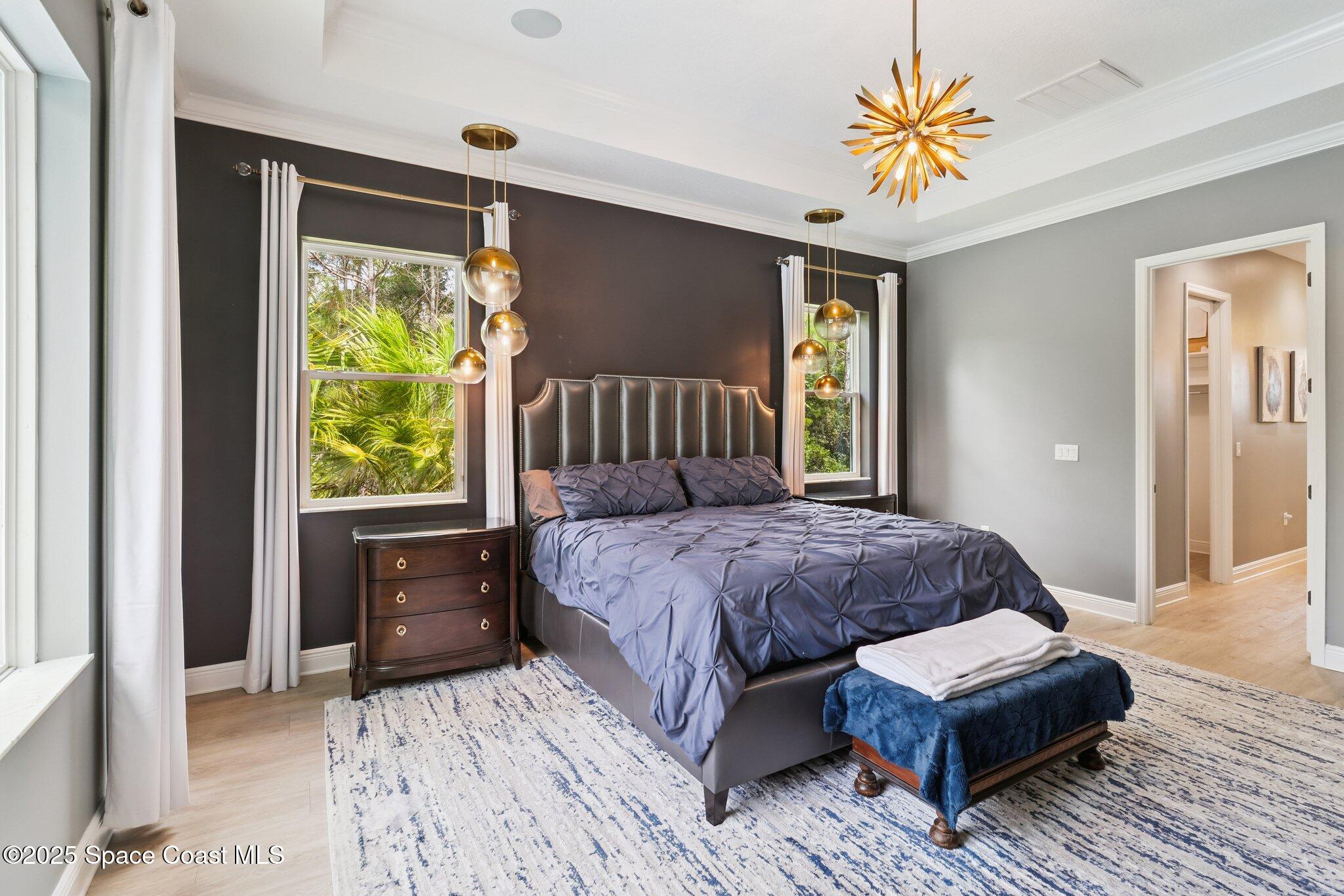 4437 Preservation Circle Melbourne, FL 32934 - Photo 10 of 40 a bedroom with a bed mirror and a window