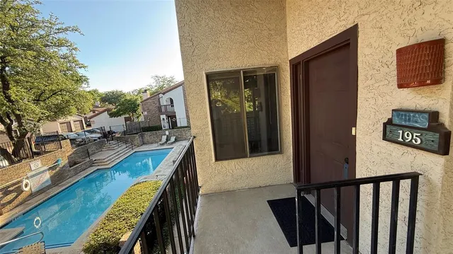 a view of a balcony with furniture and a flat screen tv