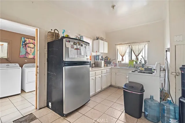 a kitchen with a refrigerator sink and stove