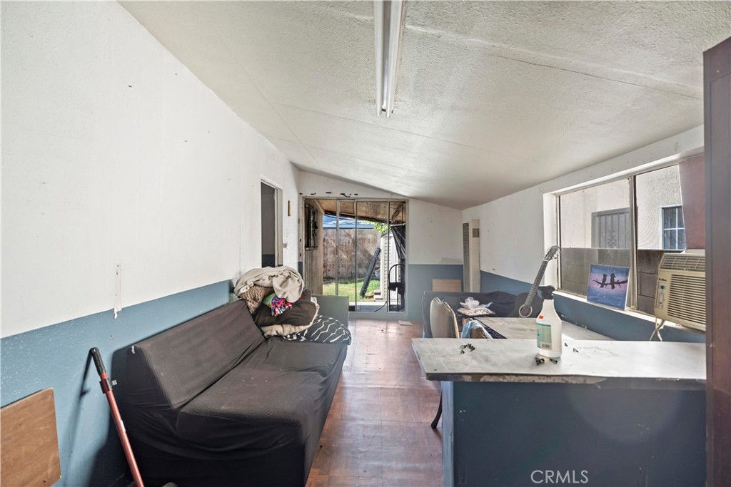 309 North Willowbrook Avenue Compton, CA 90220 - Photo 21 of 24 a living room with furniture and a potted plant