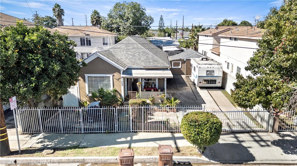 309 North Willowbrook Avenue Compton, CA 90220 - Photo 6 of 24 a front view of a house with a garden