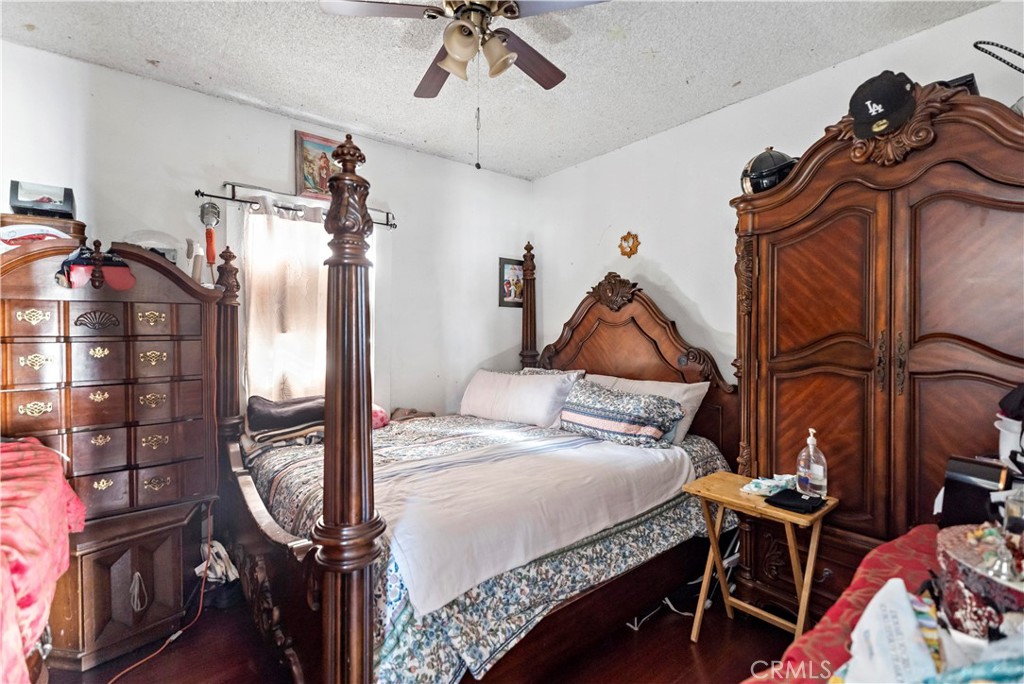 309 North Willowbrook Avenue Compton, CA 90220 - Photo 8 of 24 a bedroom with a bed and a chandelier