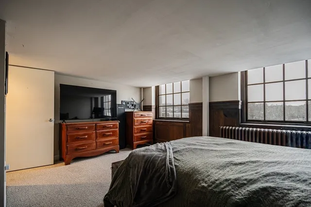 a bedroom with a bed and dresser