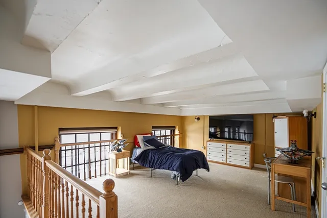 a bedroom with furniture and a window