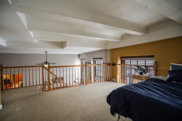 a bedroom with a large bed and a large window