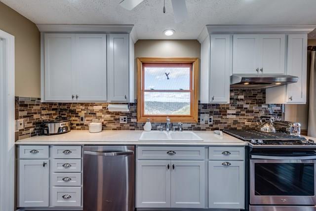 11775 Fox Hill Road Baxter, TN 38544 - Photo 4 of 19 a kitchen with granite countertop a sink stainless steel appliances and cabinets