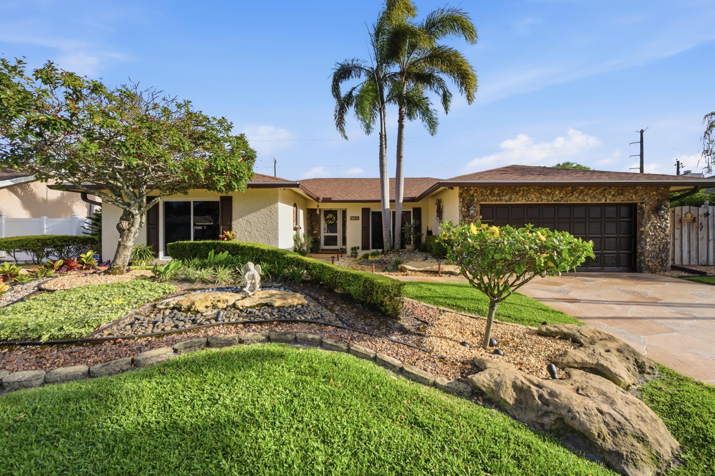 4780 Brandywine Drive Boca Raton, FL 33487 - Photo 5 of 43 a front view of a house with garden