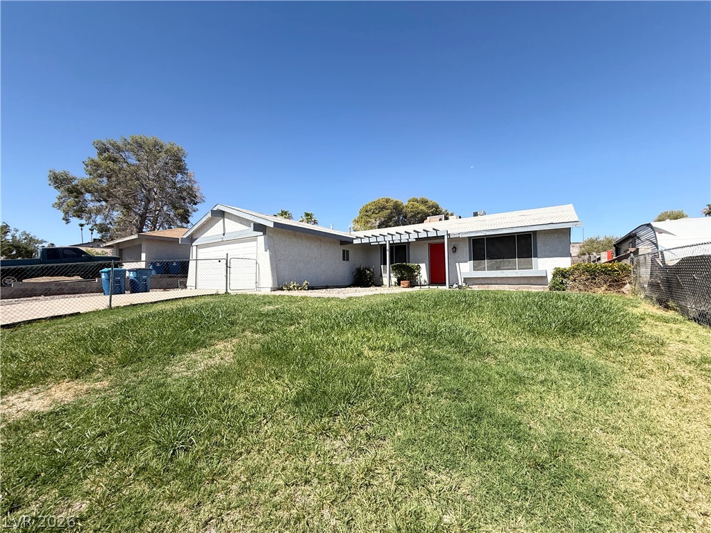 616 Greenway Road Henderson, NV 89002 - Photo 31 of 32 A classic ranch home presents with a fenced front yard and inviting red entry.
