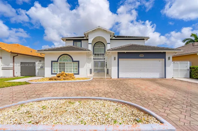 a view of pool with a house in the background