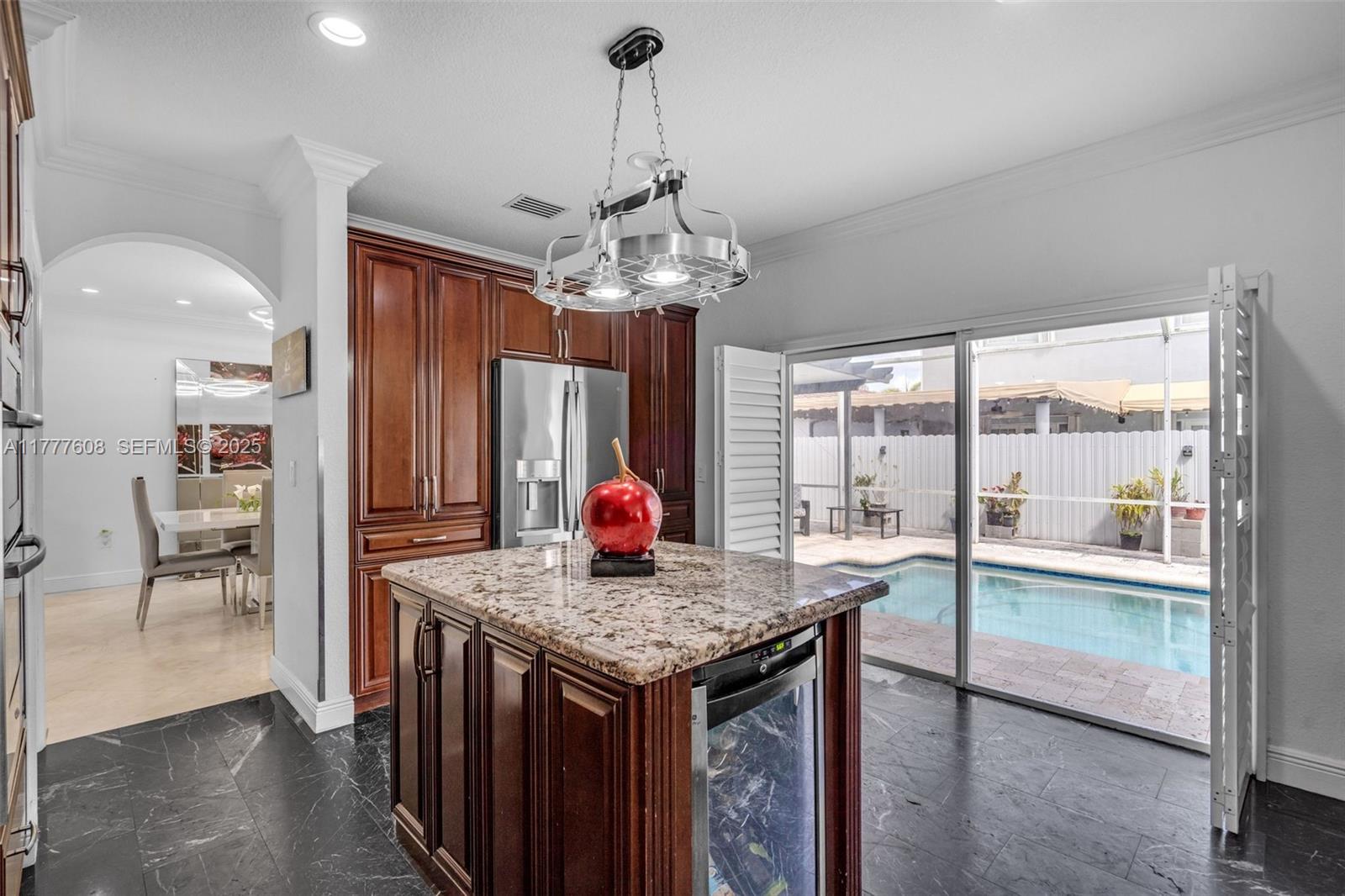 16075 Southwest 149th Terrace Miami, FL 33196 - Photo 12 of 46 a kitchen with granite countertop sink and refrigerator