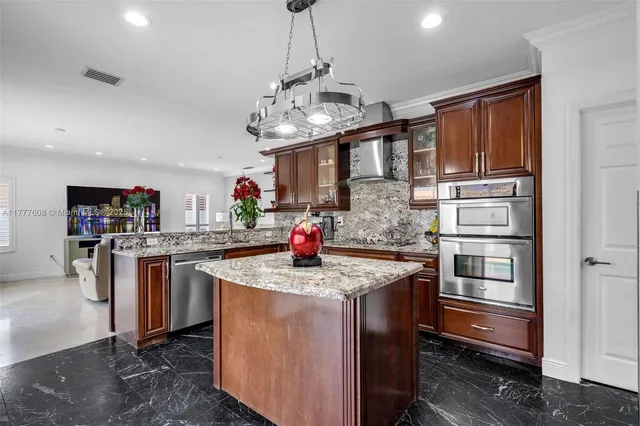 a kitchen with stainless steel appliances granite countertop a stove and a refrigerator