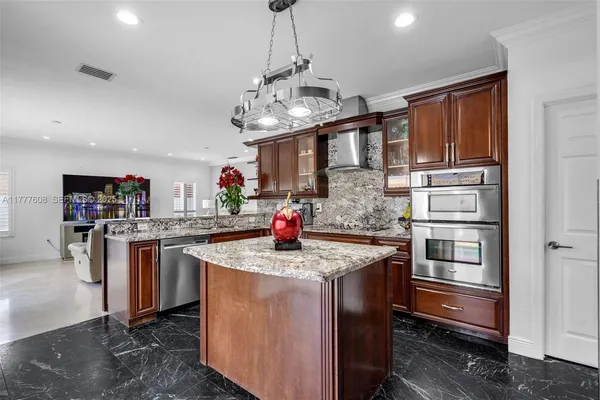 a kitchen with stainless steel appliances granite countertop a stove and a refrigerator