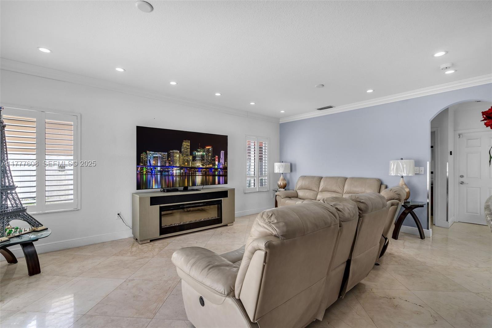 16075 Southwest 149th Terrace Miami, FL 33196 - Photo 16 of 46 a living room with furniture and a flat screen tv