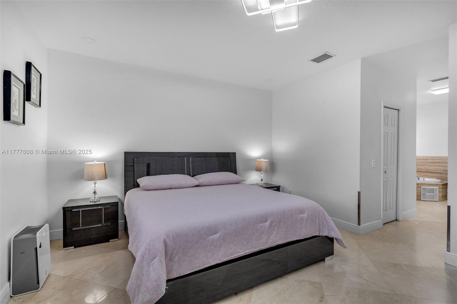 16075 Southwest 149th Terrace Miami, FL 33196 - Photo 18 of 46 a bedroom with a bed a lamp and a large closet