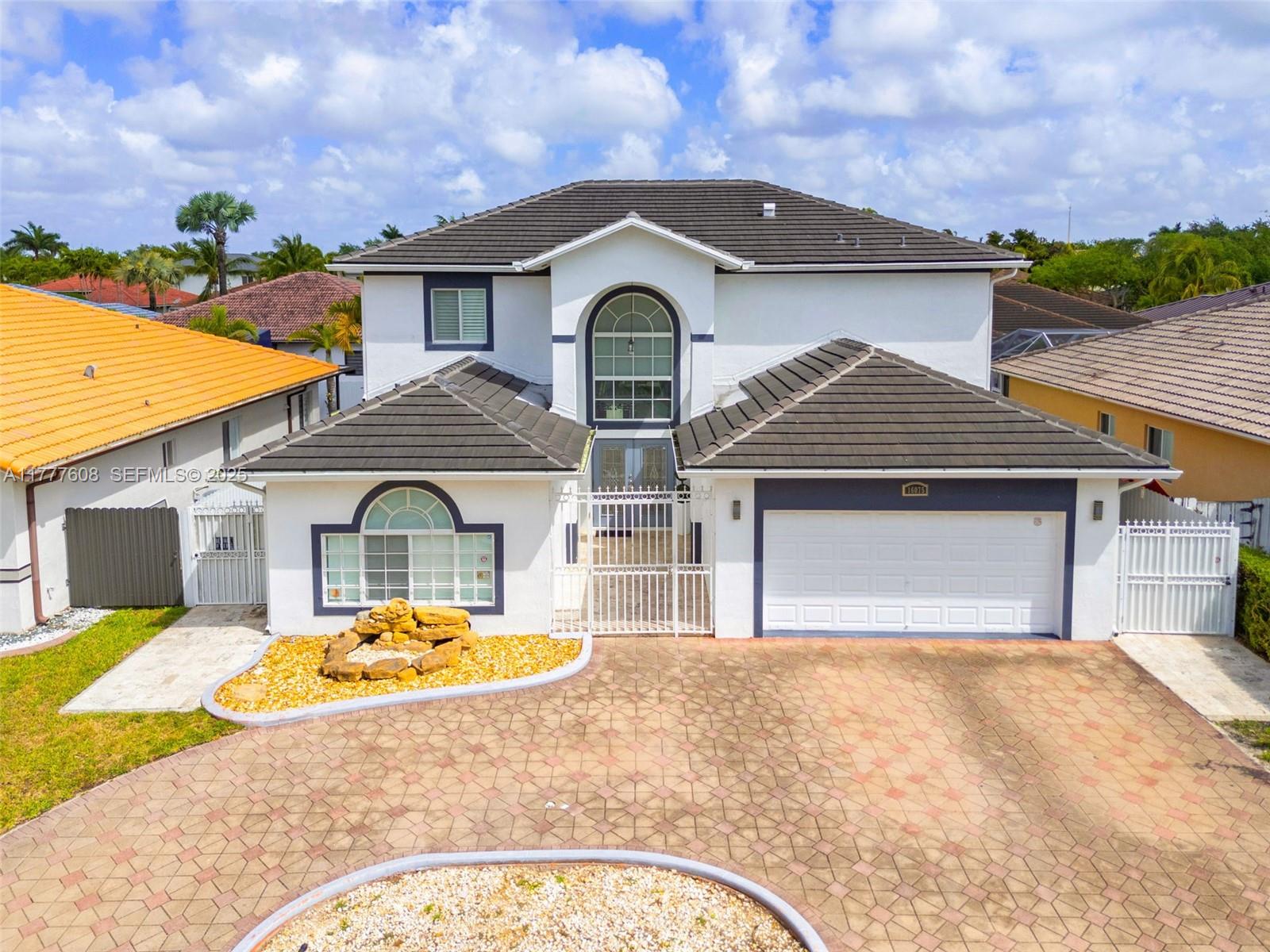 16075 Southwest 149th Terrace Miami, FL 33196 - Photo 2 of 46 a front view of a house with a yard