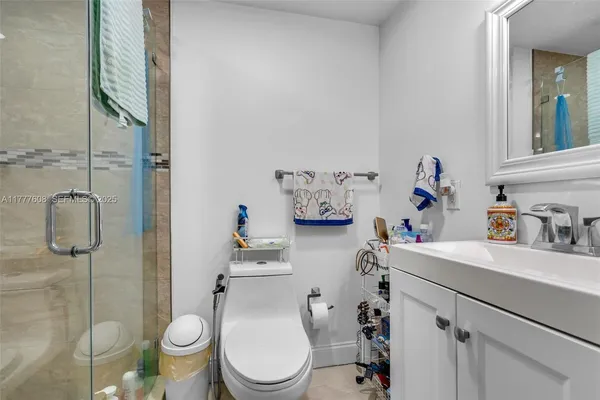 a bathroom with a sink toilet and shower
