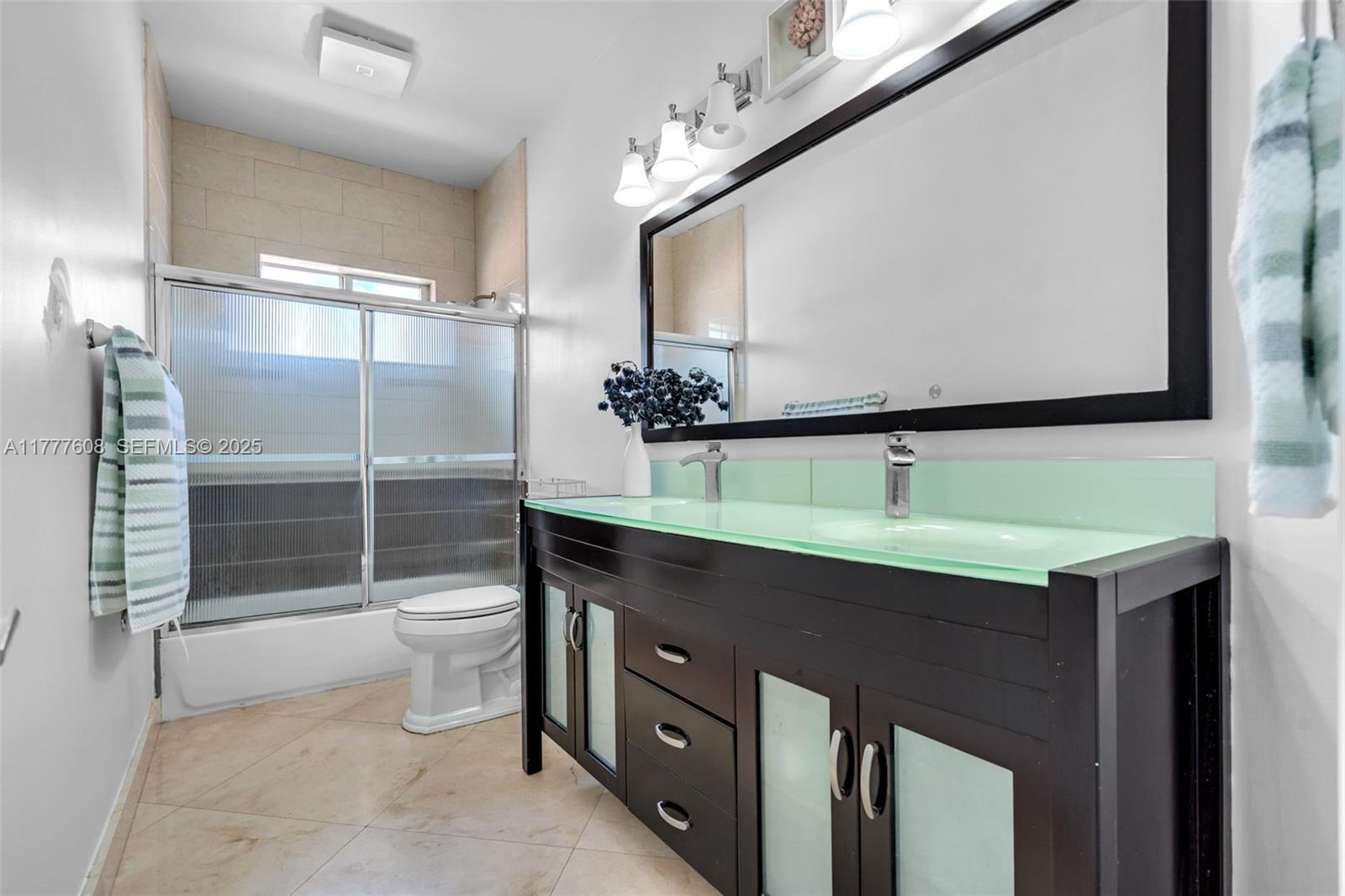 16075 Southwest 149th Terrace Miami, FL 33196 - Photo 24 of 46 a bathroom with a sink and mirror