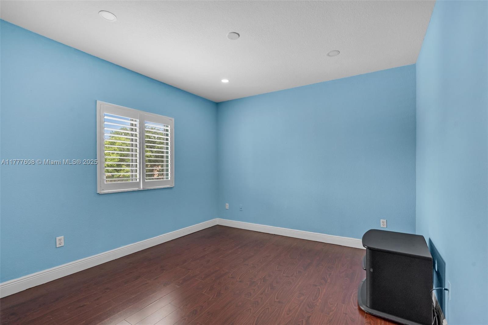 16075 Southwest 149th Terrace Miami, FL 33196 - Photo 25 of 46 a view of an empty room with wooden floor and a window