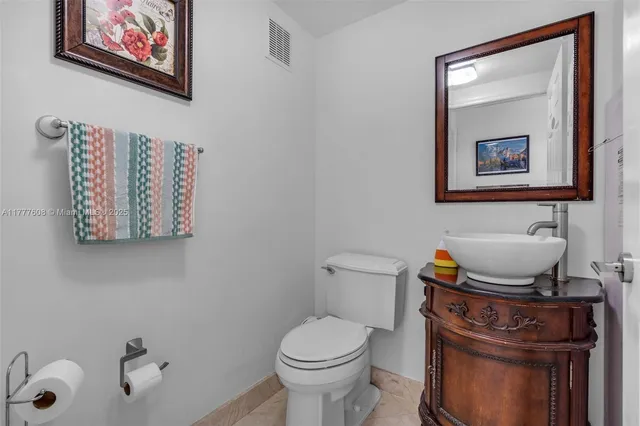 a white toilet sitting next to a bathroom sink