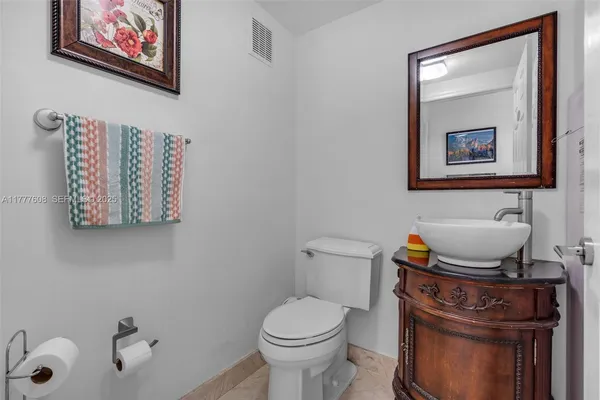a white toilet sitting next to a bathroom sink