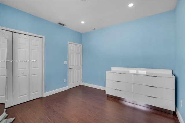 an empty room with wooden floor