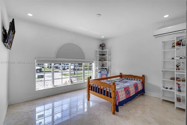 a bedroom with a bed and a window
