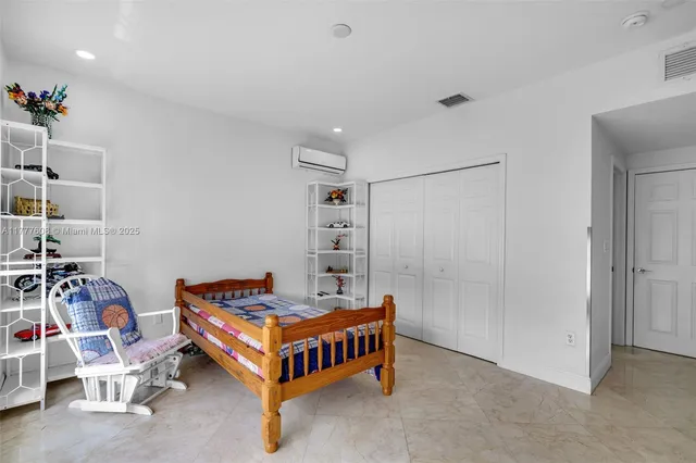 a room with a table chairs and a projector screen