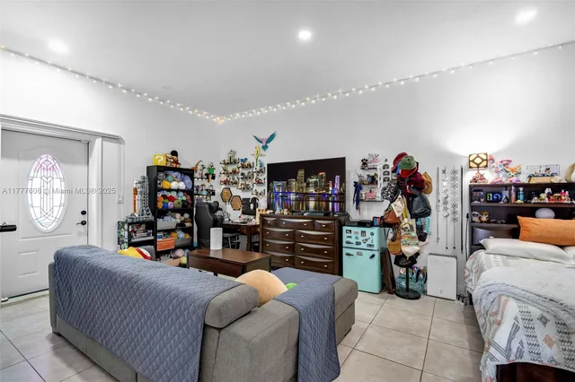 a living room with lots of furniture and a kitchen view