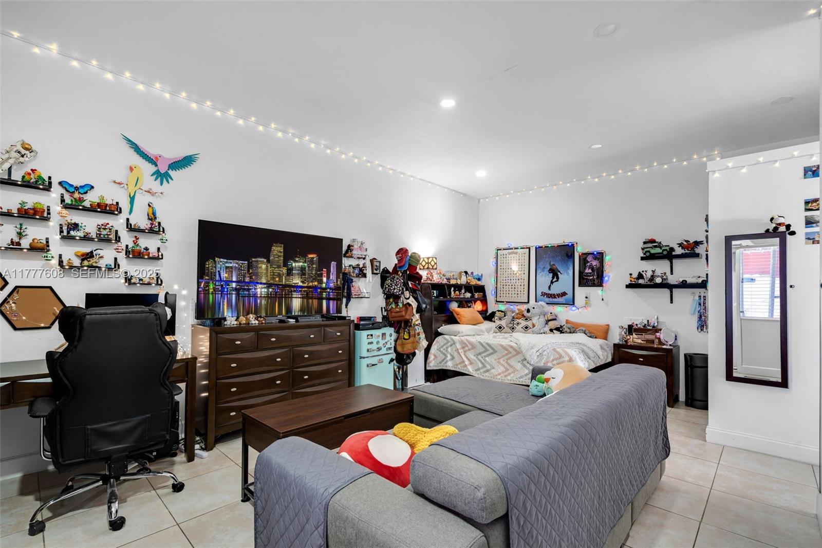 16075 Southwest 149th Terrace Miami, FL 33196 - Photo 34 of 46 a living room with furniture and a flat screen tv