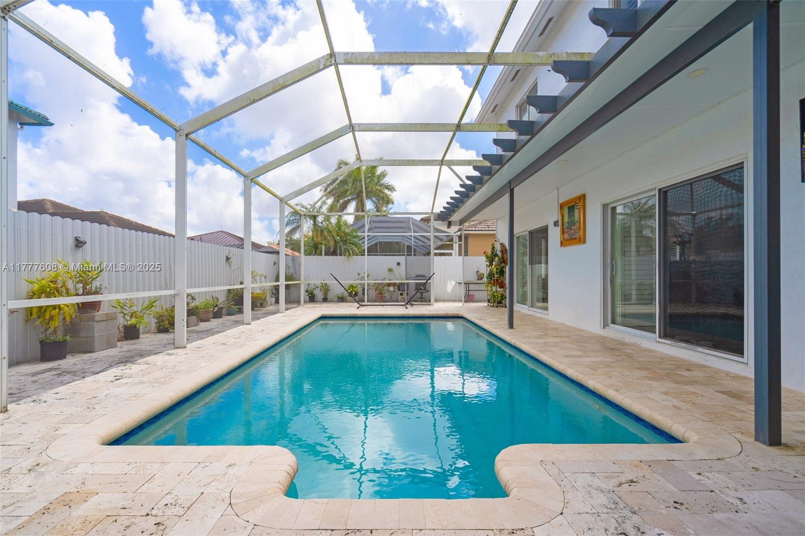 16075 Southwest 149th Terrace Miami, FL 33196 - Photo 39 of 46 a view of a swimming pool with a patio