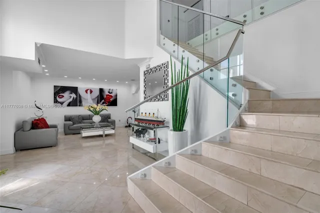 a living room with furniture and stairs