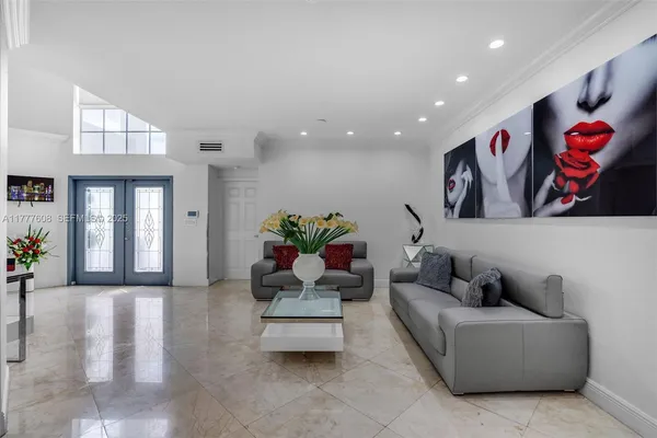 a living room with furniture and flowers