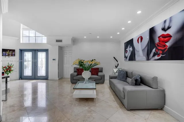 a living room with furniture and flowers