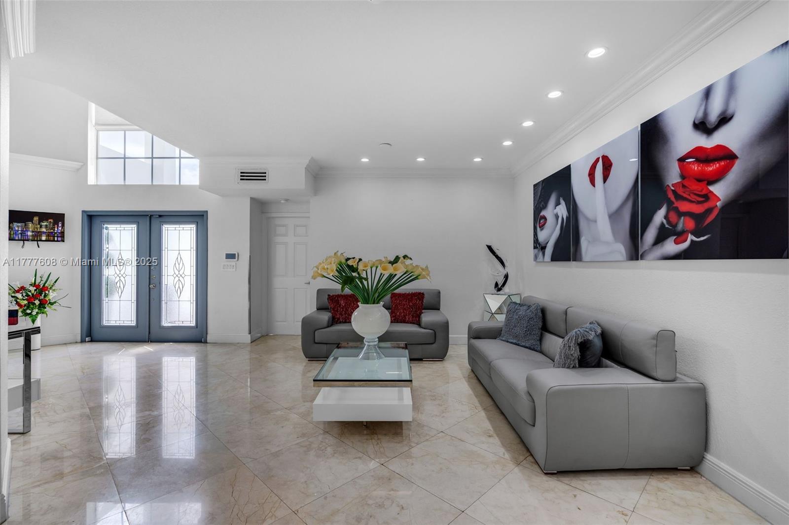 16075 Southwest 149th Terrace Miami, FL 33196 - Photo 8 of 46 a living room with furniture and flowers