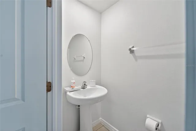 a bathroom with a granite countertop sink a toilet and a mirror
