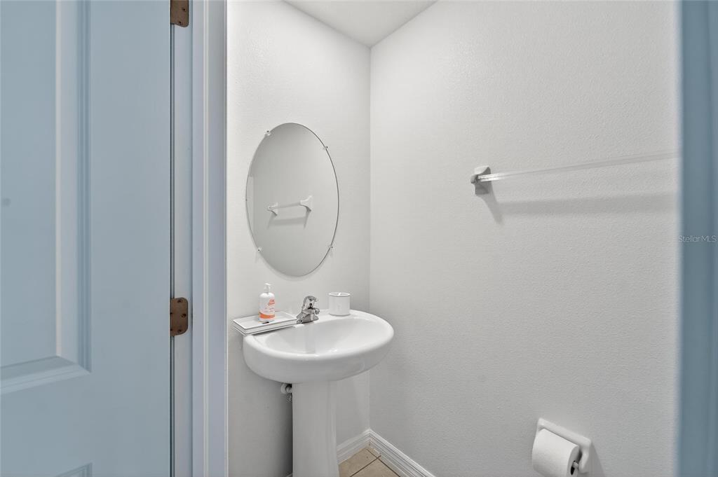 14446 Editors Note Street Ruskin, FL 33573 - Photo 27 of 52 a bathroom with a sink and mirror