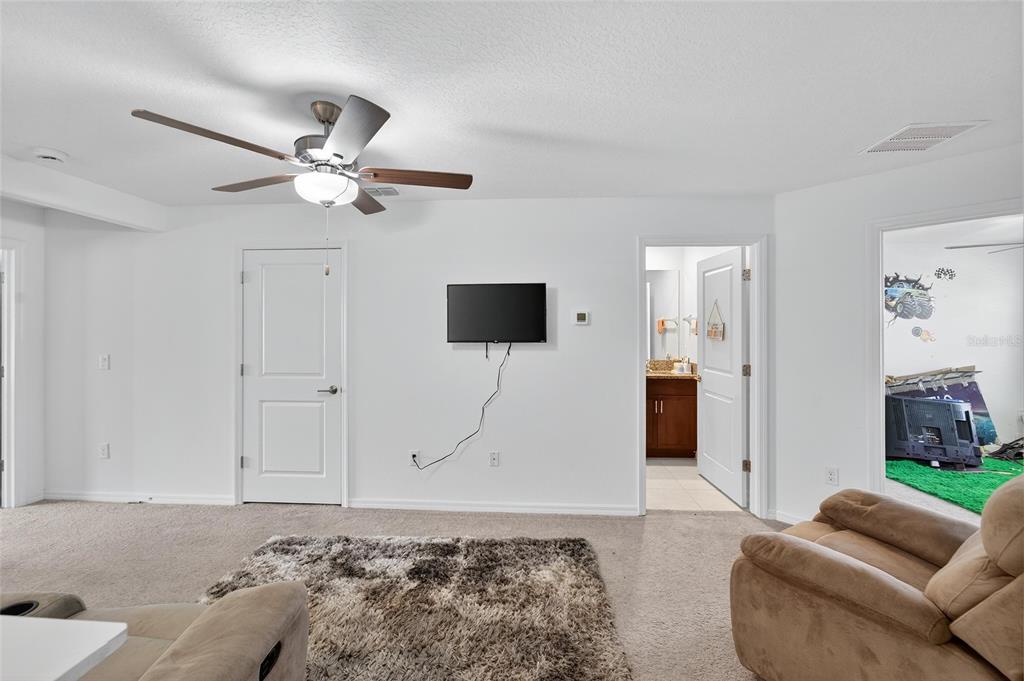 14446 Editors Note Street Ruskin, FL 33573 - Photo 32 of 52 a living room with furniture and a flat screen tv