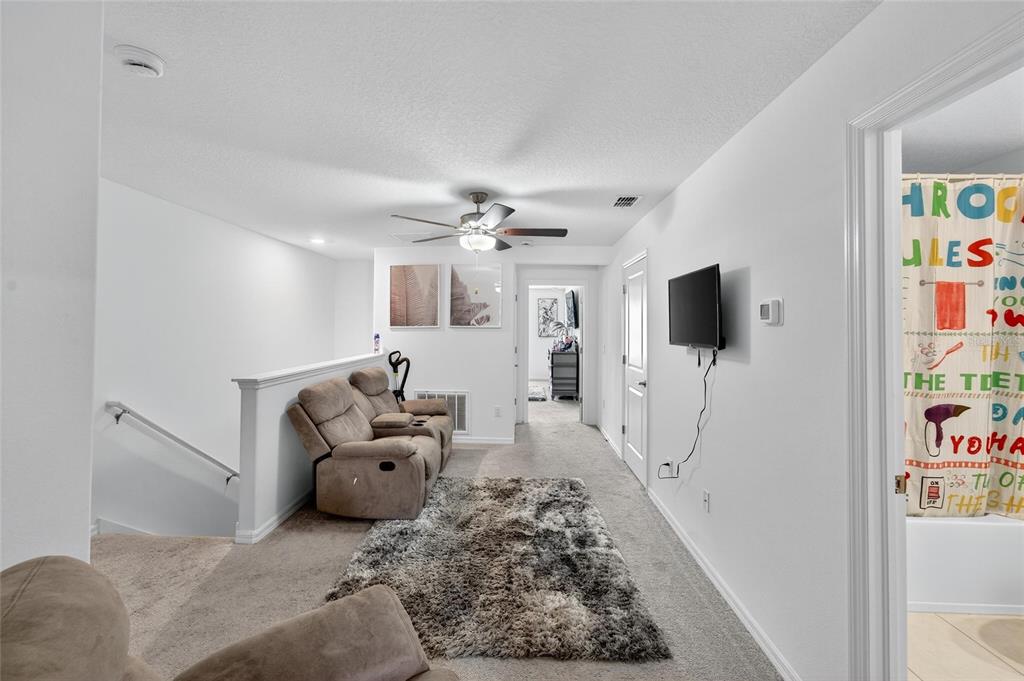14446 Editors Note Street Ruskin, FL 33573 - Photo 33 of 52 a living room with furniture and a flat screen tv