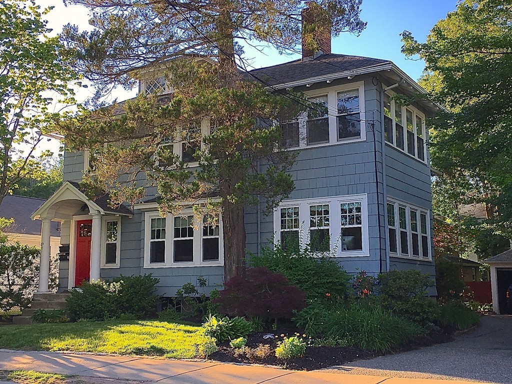 89-91 Elm Road, Unit 1 Newton, MA 02460 - Photo 15 of 18 a front view of a house with a yard and potted plants