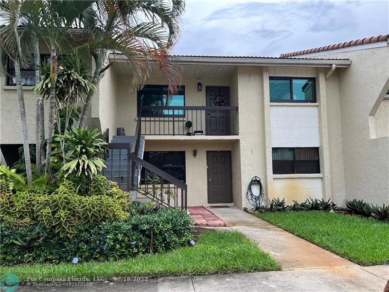 22465 Southwest 61st Way, Unit 241 Boca Raton, FL 33428 - Photo 1 of 18 a front view of house with yard