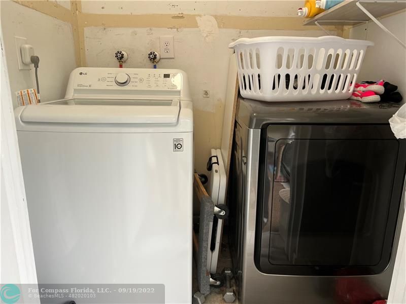 22465 Southwest 61st Way, Unit 241 Boca Raton, FL 33428 - Photo 16 of 18 a utility room with dryer and washer