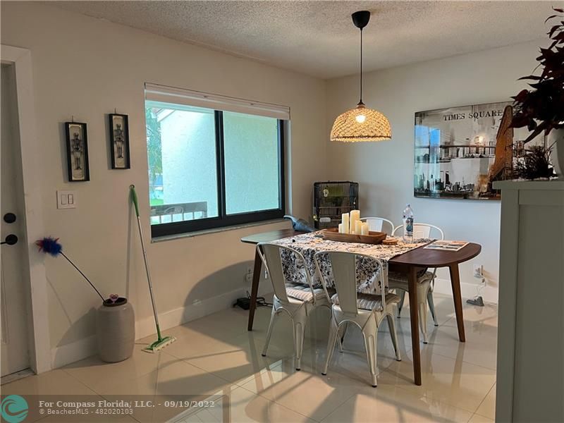 22465 Southwest 61st Way, Unit 241 Boca Raton, FL 33428 - Photo 8 of 18 a dining room with furniture and window