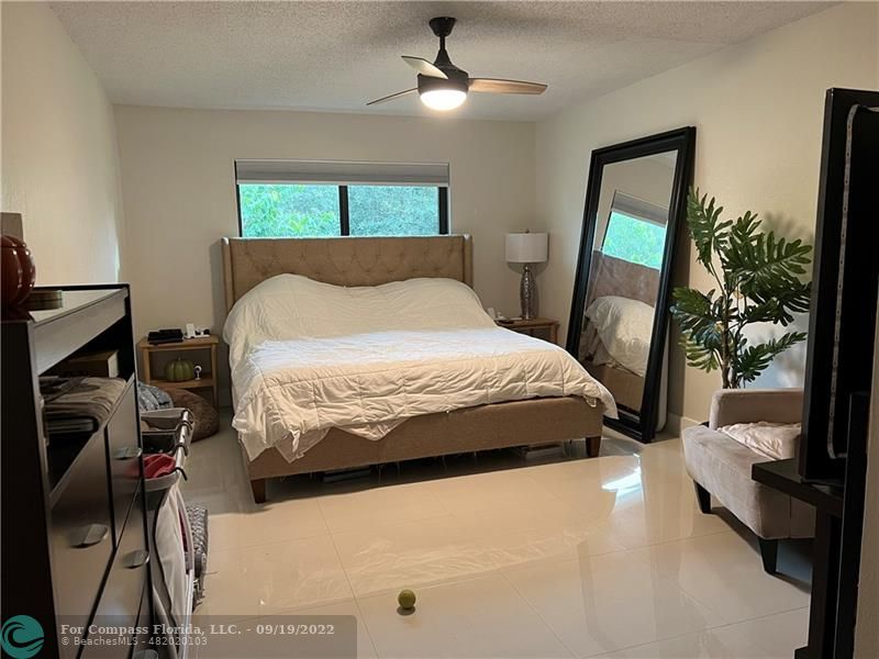 22465 Southwest 61st Way, Unit 241 Boca Raton, FL 33428 - Photo 9 of 18 a bedroom with a large bed and a window