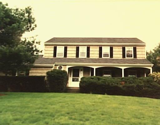 25 Chasmars Pond Road Darien, CT 06820 - Photo 1 of 1 a front view of a house with a yard