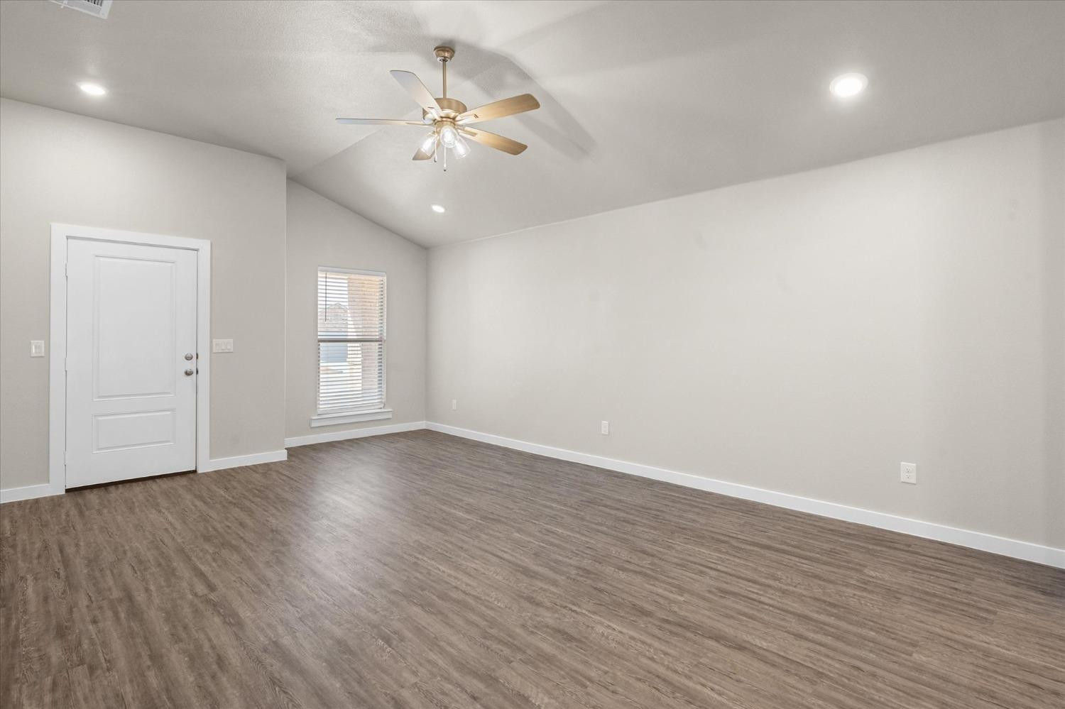 1608 142nd Street Lubbock, TX 79423 - Photo 6 of 20 wooden floor in an empty room with a window